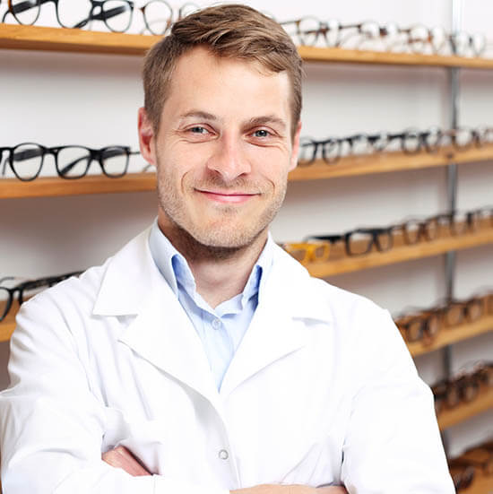 Optician. Smiling Optician In The Optical Salon.